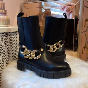 Black faux leather boots with gold chain